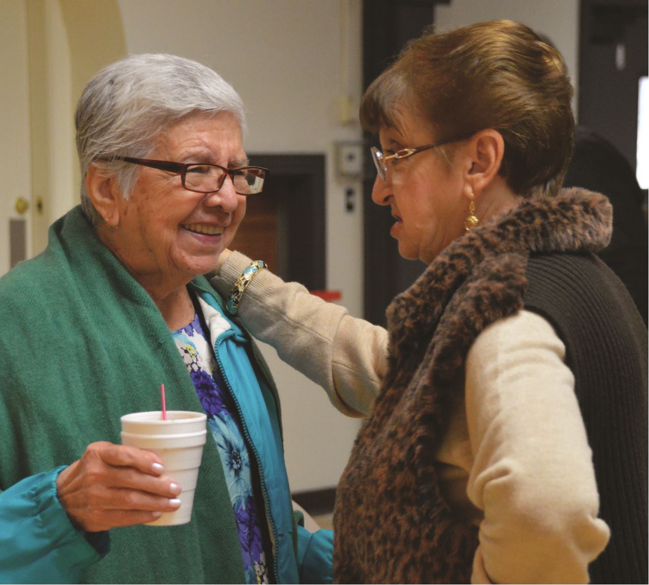 Seniors in a caring conversation, smiling