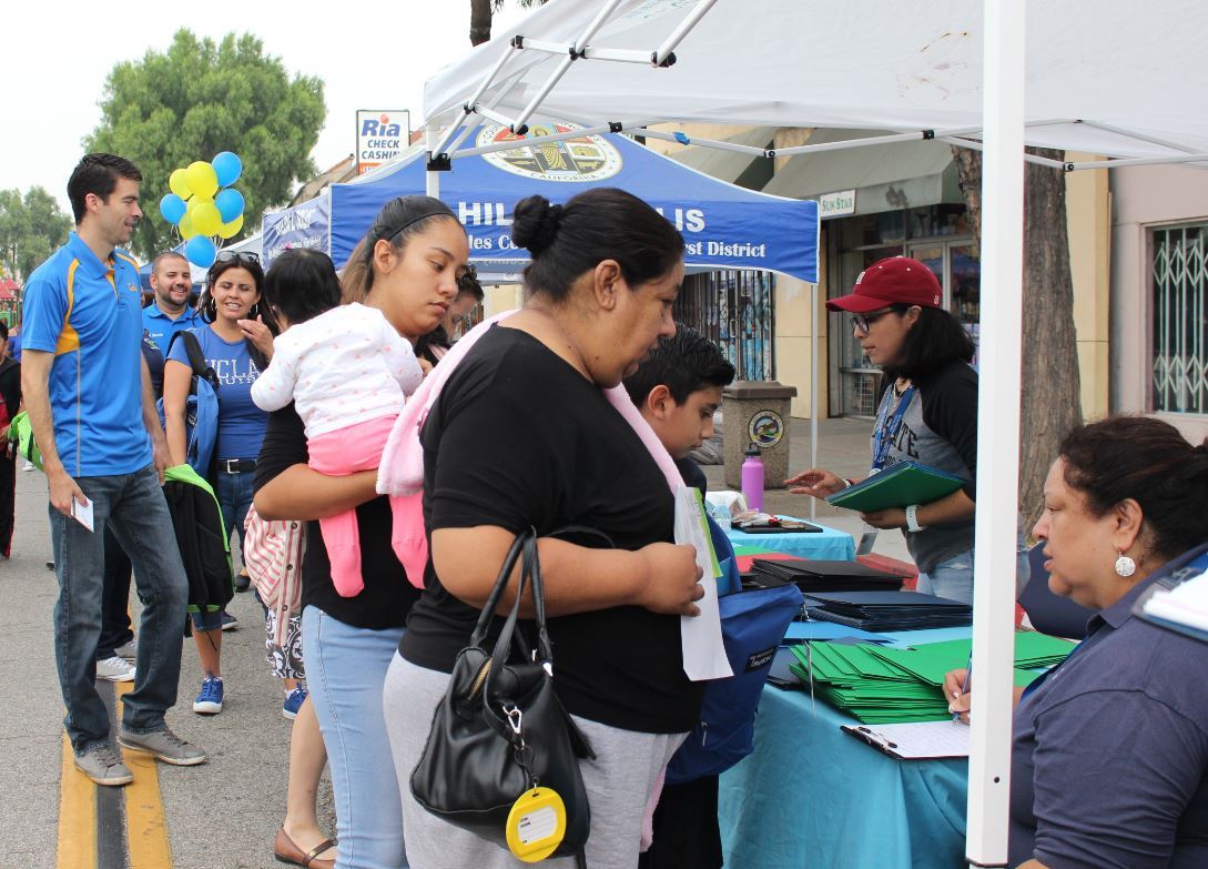 El Monte resident stops by a booth for information on school supplies.
